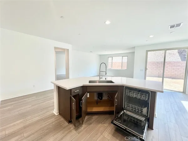 a room with a table chairs and wooden floor