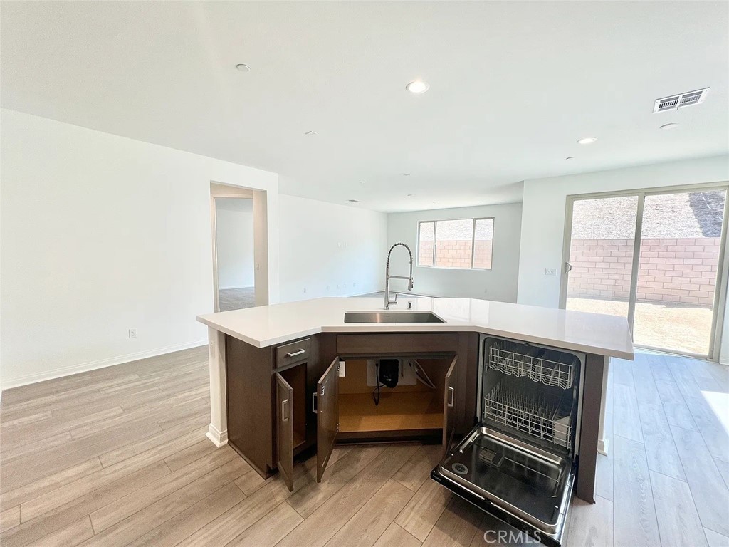 8285 Tristan Lane Riverside, CA 92507 - Photo 8 of 38 a room with a table chairs and wooden floor