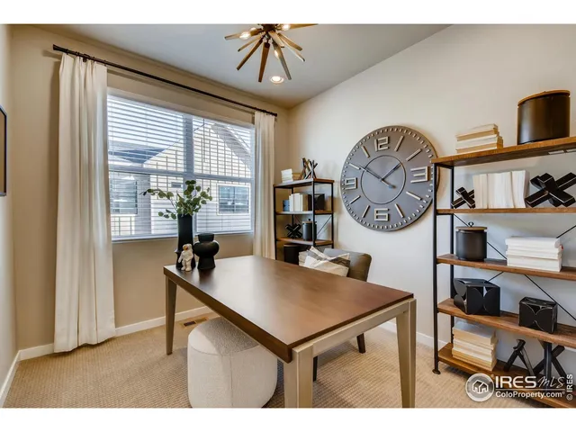 a living room with furniture a window and a clock