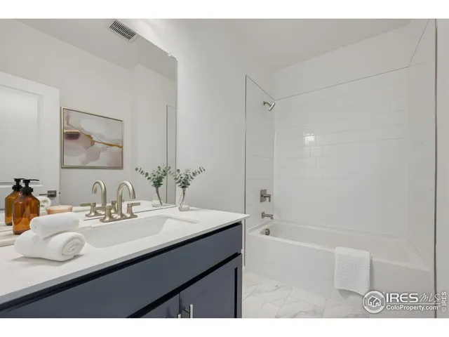 a bathroom with a sink a shower and a mirror