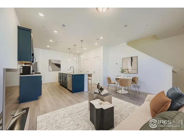 a living room with furniture and kitchen view