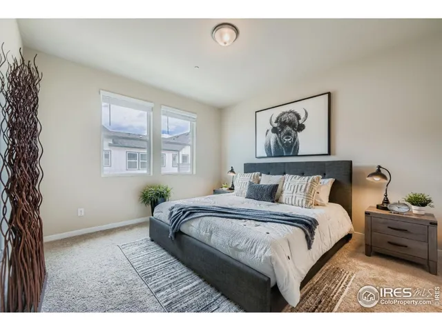 a bedroom with a bed and a painting on the wall