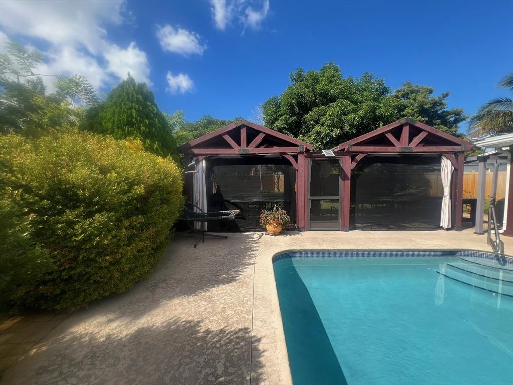 861 Southwest 55th Way Margate, FL 33068 - Photo 12 of 45 a front view of a house with a yard