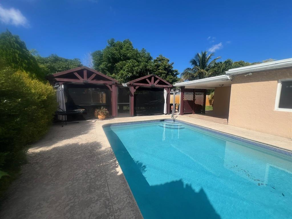 861 Southwest 55th Way Margate, FL 33068 - Photo 14 of 45 a view of a house with pool