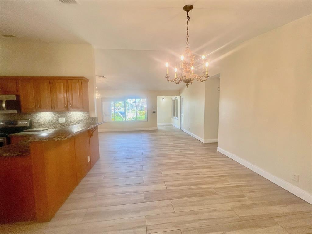 861 Southwest 55th Way Margate, FL 33068 - Photo 15 of 45 a kitchen with stainless steel appliances granite countertop a refrigerator a sink dishwasher a stove and a wooden floors