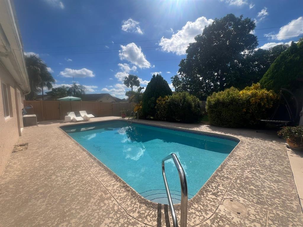 861 Southwest 55th Way Margate, FL 33068 - Photo 25 of 45 a view of a swimming pool with a yard