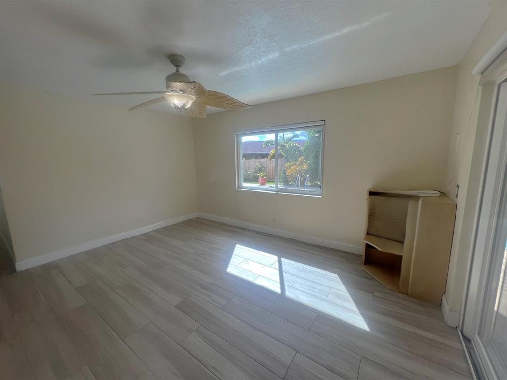 861 Southwest 55th Way Margate, FL 33068 - Photo 30 of 45 wooden floor in an empty room with a window