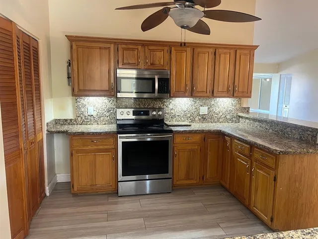 a open kitchen with cabinets and wooden floor