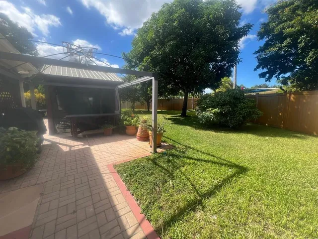 a view of a swimming pool with a yard