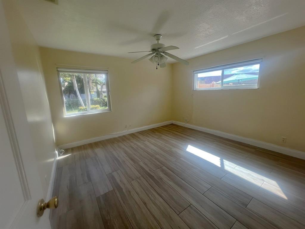 861 Southwest 55th Way Margate, FL 33068 - Photo 38 of 45 a view of an empty room with wooden floor and a window