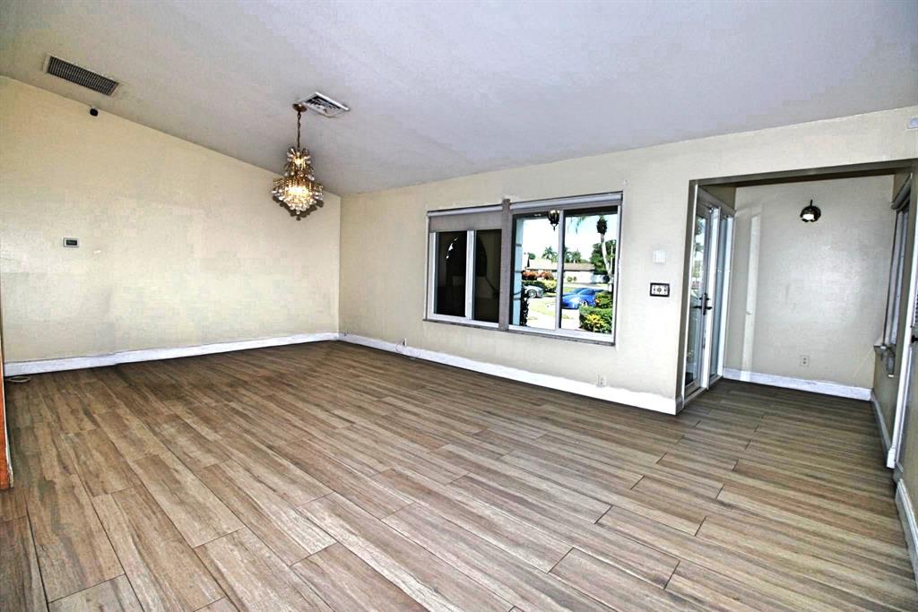 861 Southwest 55th Way Margate, FL 33068 - Photo 44 of 45 an empty room with wooden floor and windows