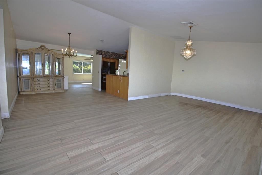 861 Southwest 55th Way Margate, FL 33068 - Photo 45 of 45 an empty room with wooden floor and windows