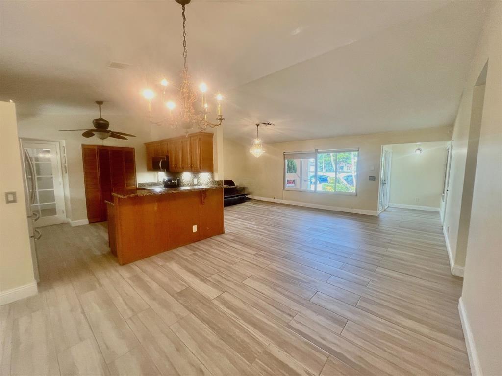 861 Southwest 55th Way Margate, FL 33068 - Photo 5 of 45 a open kitchen with cabinets and wooden floor