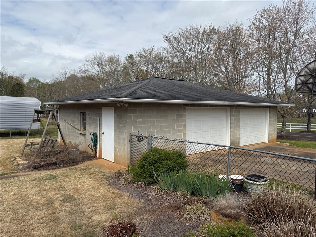 121 Nautical Way Anderson, SC 29625 - Photo 36 of 37 A detached two-car garage crafted from sturdy concrete blocks offers ample storage and utility space.