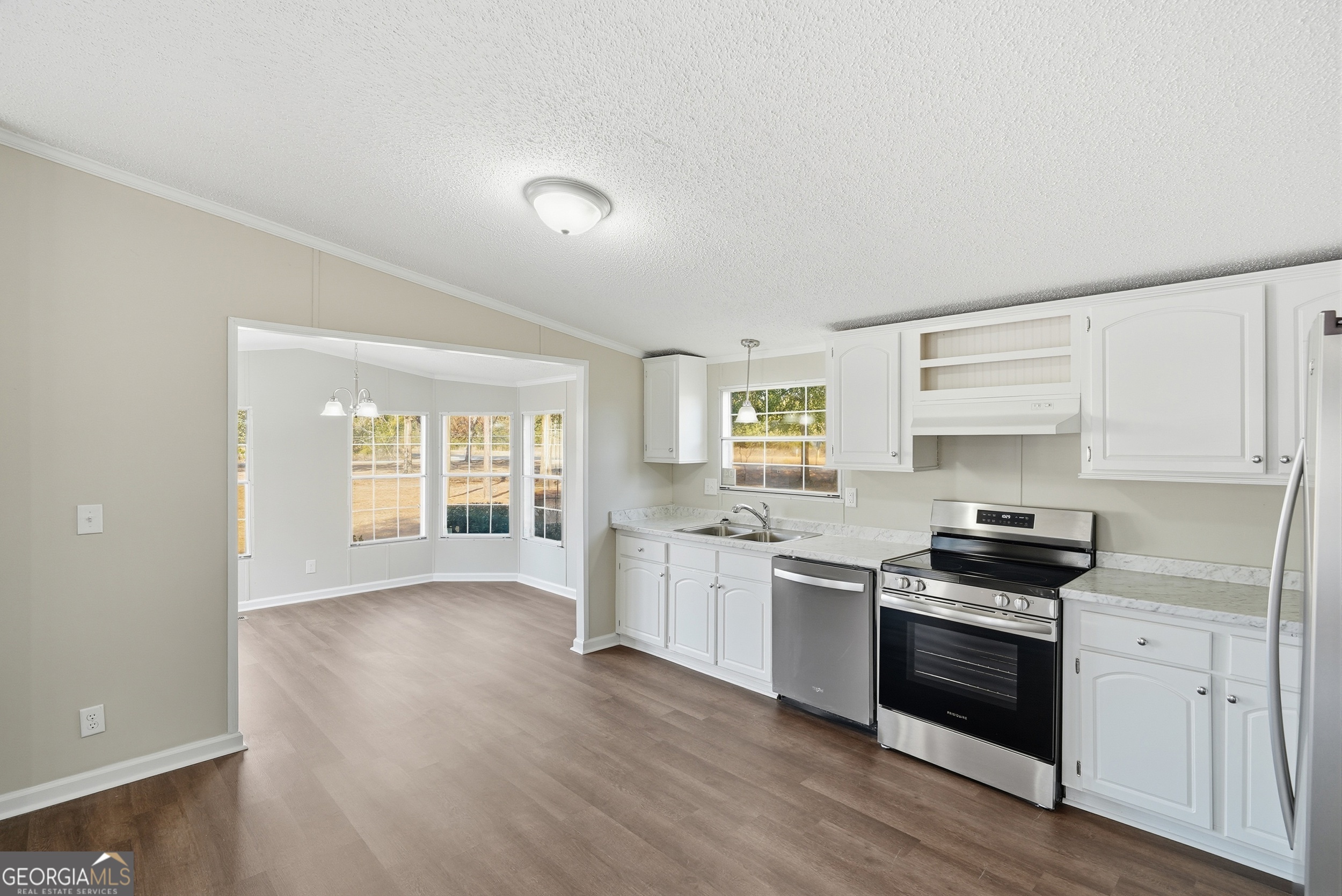492 Doctortown Road Jesup, GA 31545 - Photo 11 of 25 a kitchen with granite countertop a stove top oven sink and cabinets
