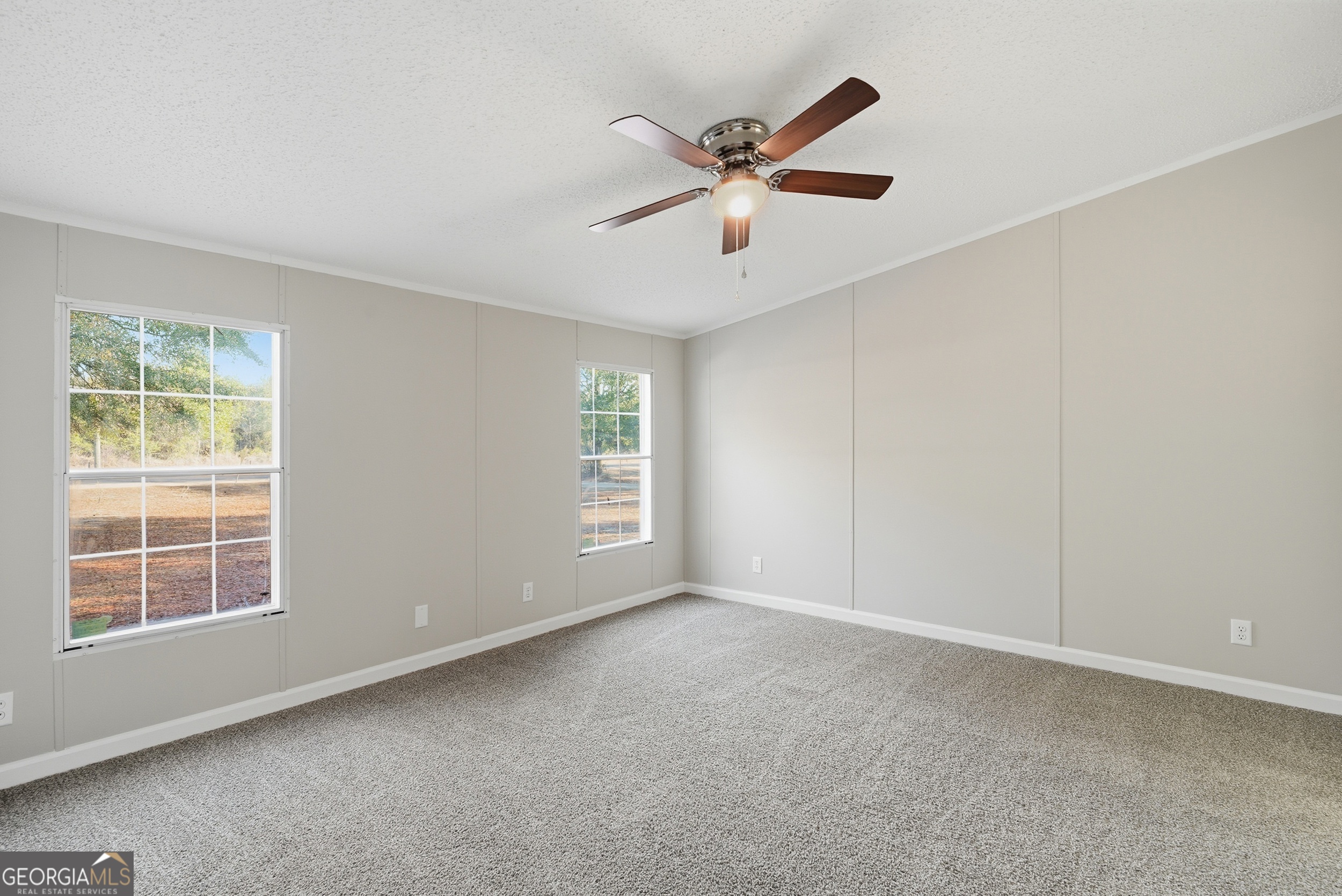 492 Doctortown Road Jesup, GA 31545 - Photo 12 of 25 a view of a big room with windows and chandelier fan