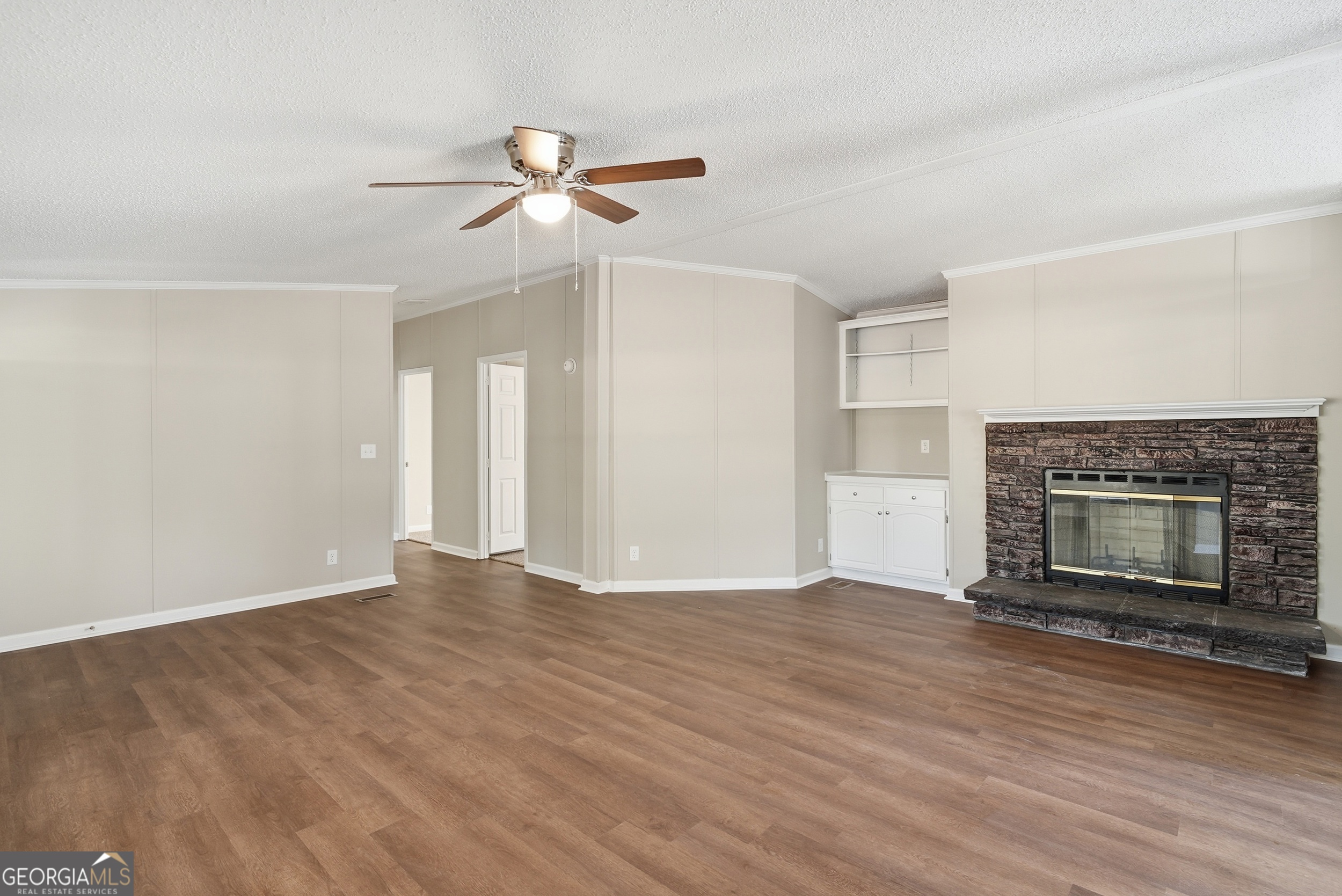 492 Doctortown Road Jesup, GA 31545 - Photo 7 of 25 a view of empty room with wooden floor and fireplace