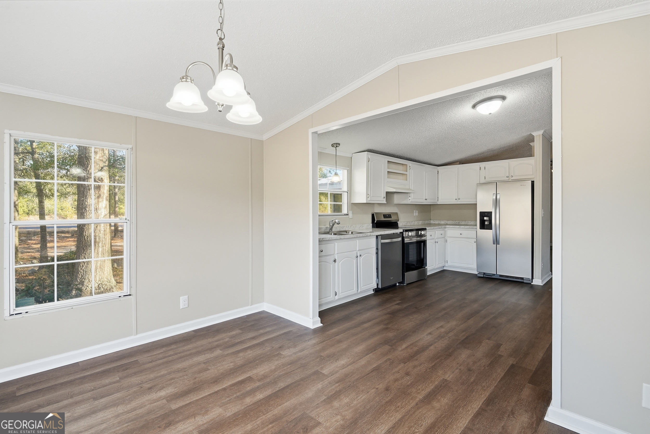 492 Doctortown Road Jesup, GA 31545 - Photo 10 of 25 a view of a kitchen with a sink and dishwasher a refrigerator with wooden floor
