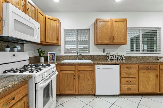 a kitchen with stainless steel appliances granite countertop a stove and a sink