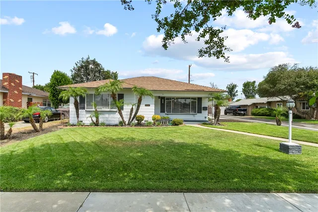 a front view of a house with a yard table and chairs