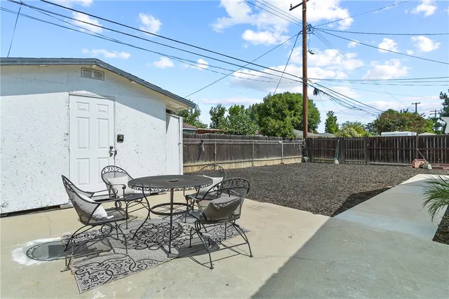 a patio with table and chairs