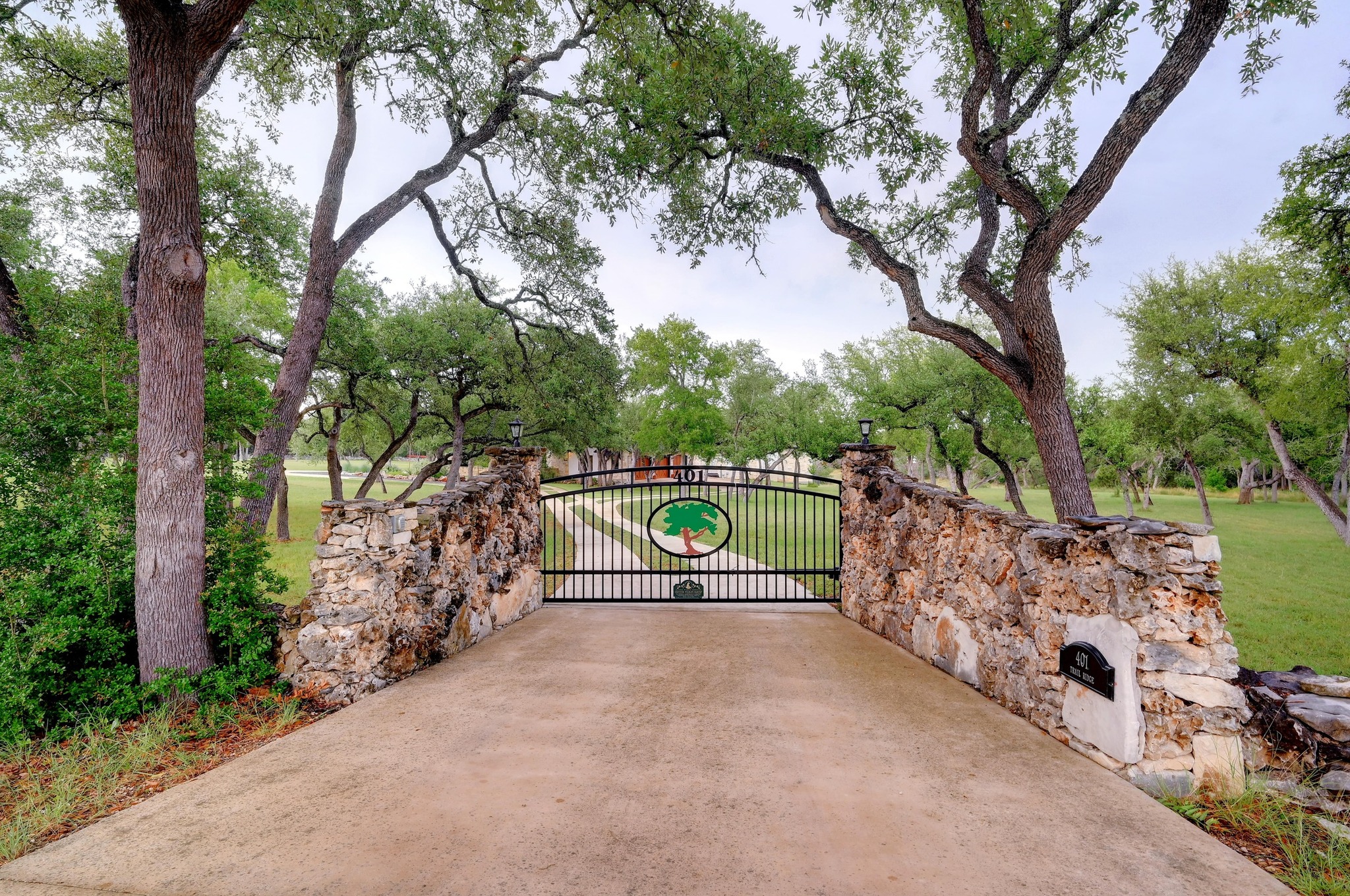 401 Trail Ridge Road Wimberley, TX 78676 - Photo 2 of 34 Gate with a lawn and a patio