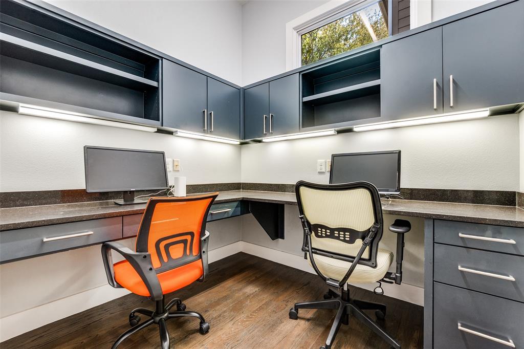 7912 Hanover Street Dallas, TX 75225 - Photo 12 of 29 Built-in corner desk area featuring dark wood-finish flooring, ample cabinetry with silver hardware, under-cabinet task lighting, and a high window