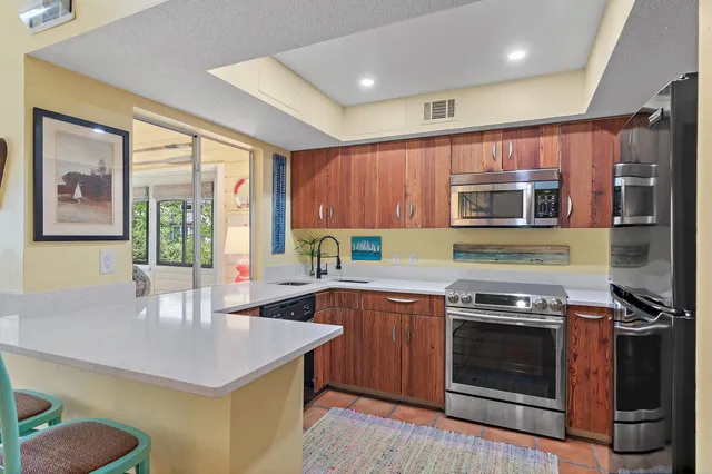 a kitchen with stainless steel appliances a stove a sink and a microwave