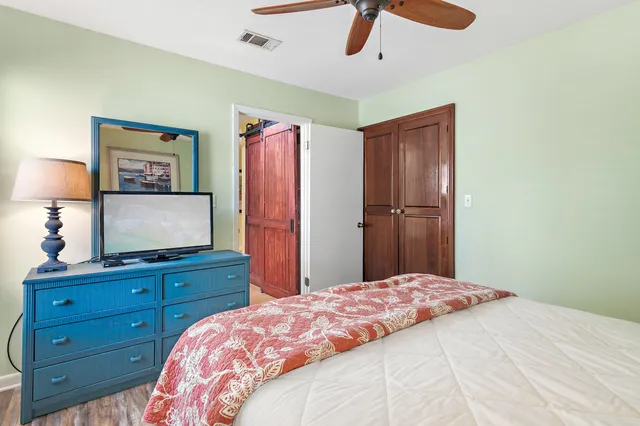 a bedroom with a bed and a dresser