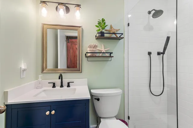 a bathroom with a sink a toilet and mirror