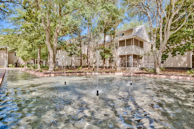 a view of a large white house with a yard