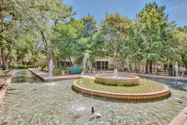 a view of a fountain in front of a house
