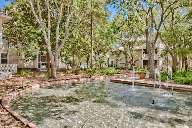 a backyard of a house with large trees