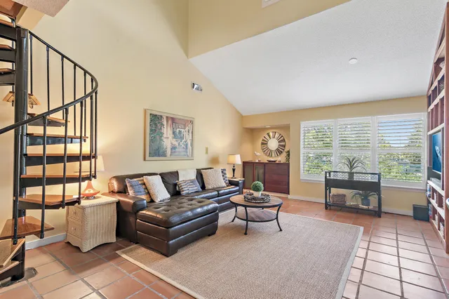 a living room with furniture and a floor to ceiling window