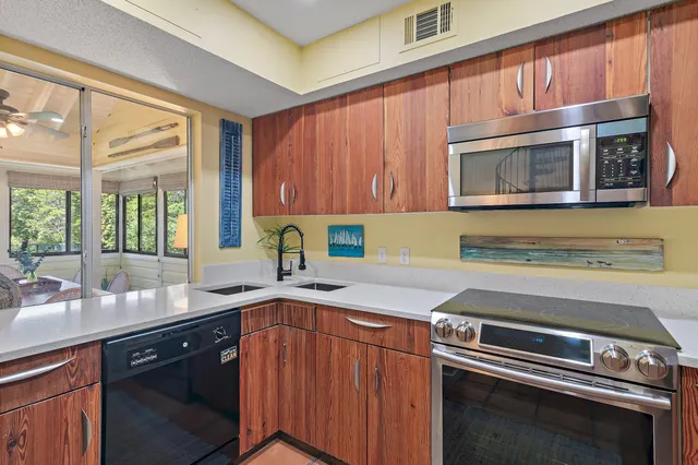 a kitchen with a sink stove and cabinets