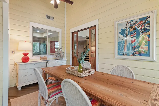 a dining room with furniture and wooden floor
