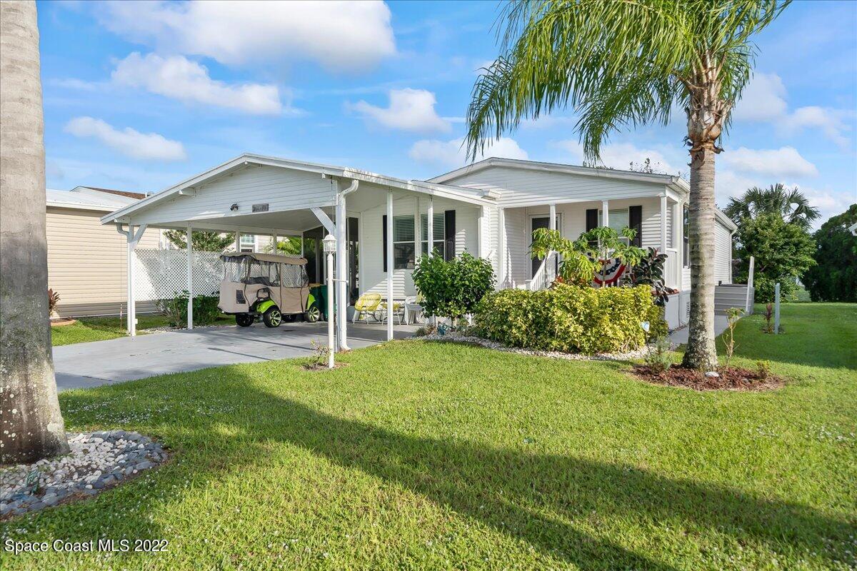 1017 Barefoot Circle Sebastian, FL 32976 - Photo 1 of 33 a front view of a house with garden