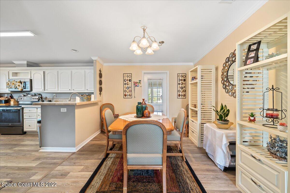 1017 Barefoot Circle Sebastian, FL 32976 - Photo 15 of 33 a view of a dining room with furniture and chandelier