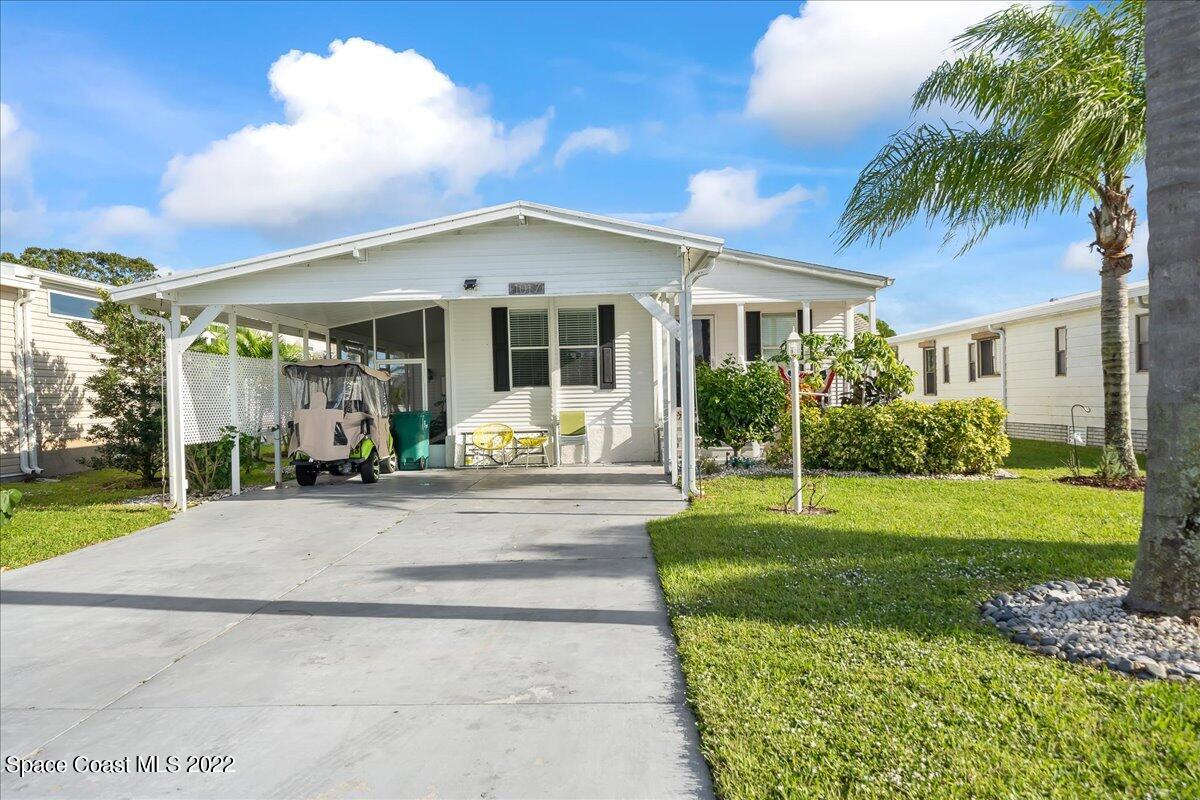 1017 Barefoot Circle Sebastian, FL 32976 - Photo 2 of 33 a front view of a house with garden