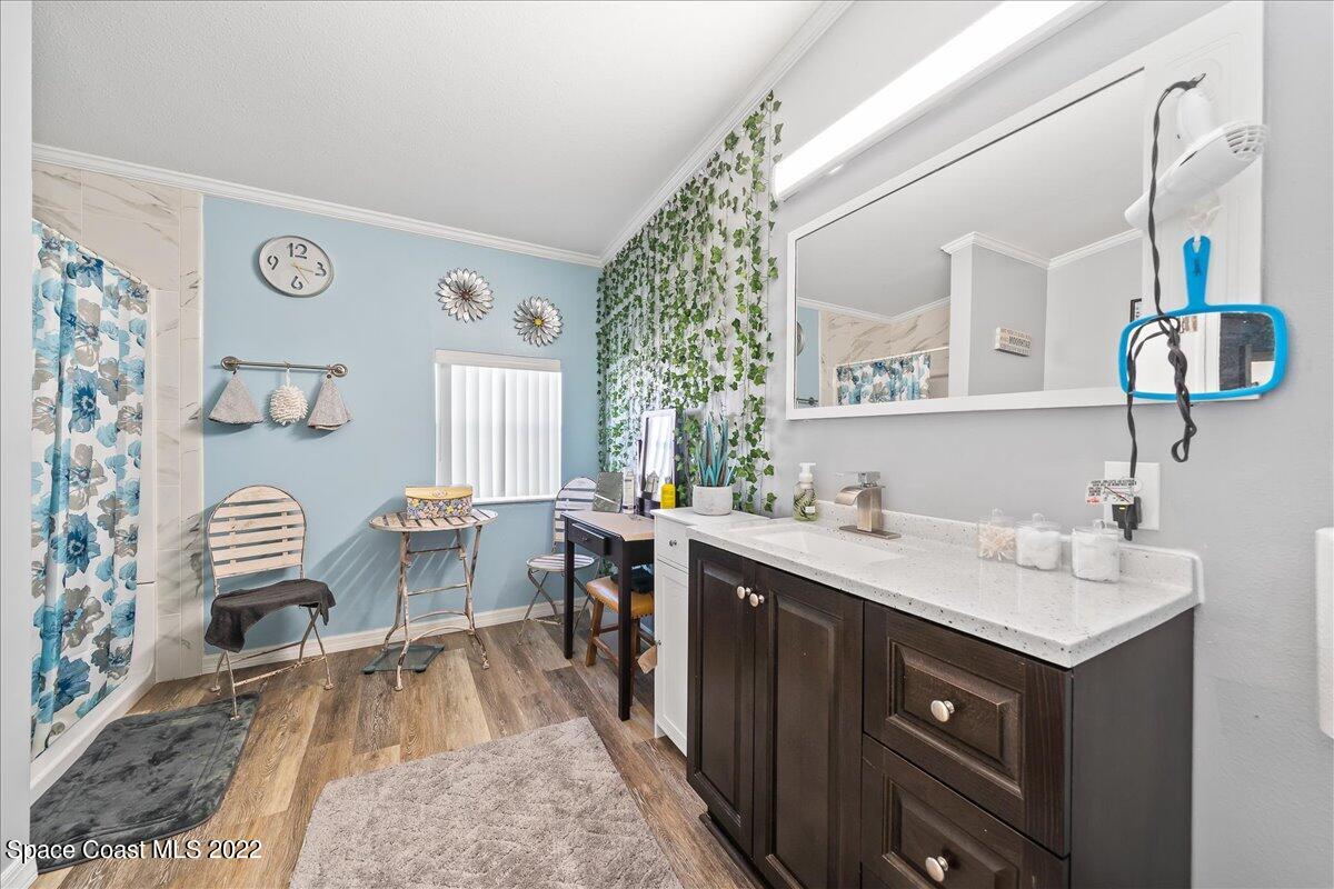 1017 Barefoot Circle Sebastian, FL 32976 - Photo 21 of 33 a spacious bathroom with a sink and a mirror