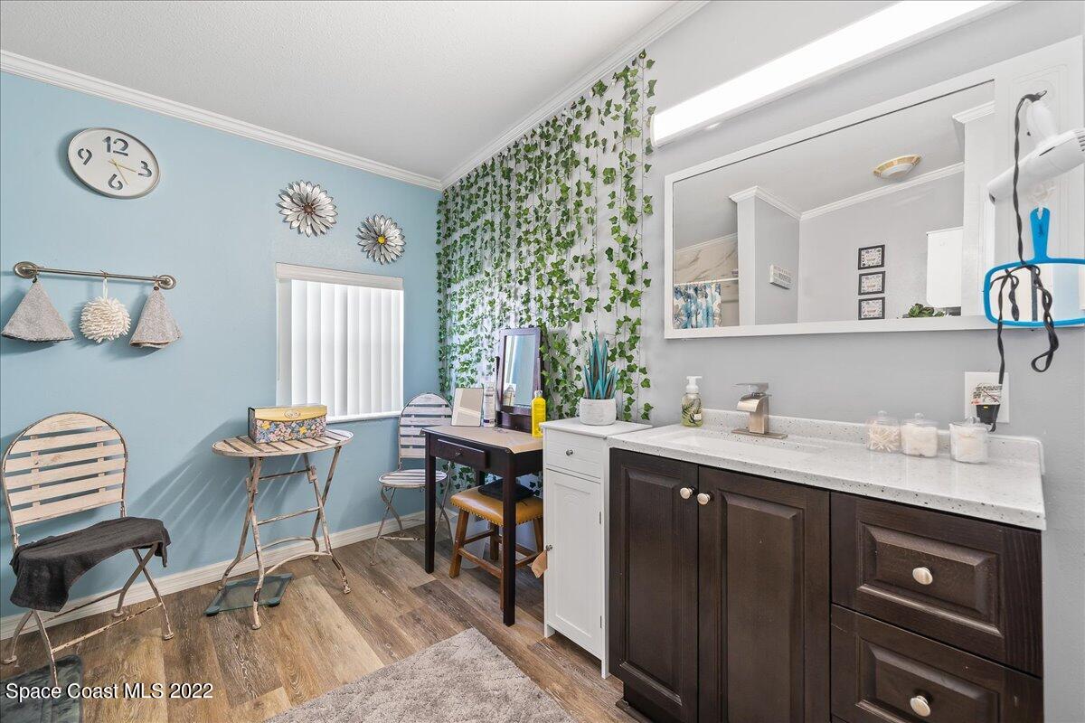 1017 Barefoot Circle Sebastian, FL 32976 - Photo 22 of 33 a spacious bathroom with a double vanity sink and a window