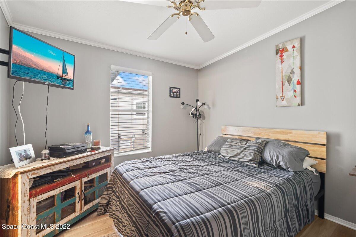 1017 Barefoot Circle Sebastian, FL 32976 - Photo 25 of 33 a bedroom with a bed and a chandelier