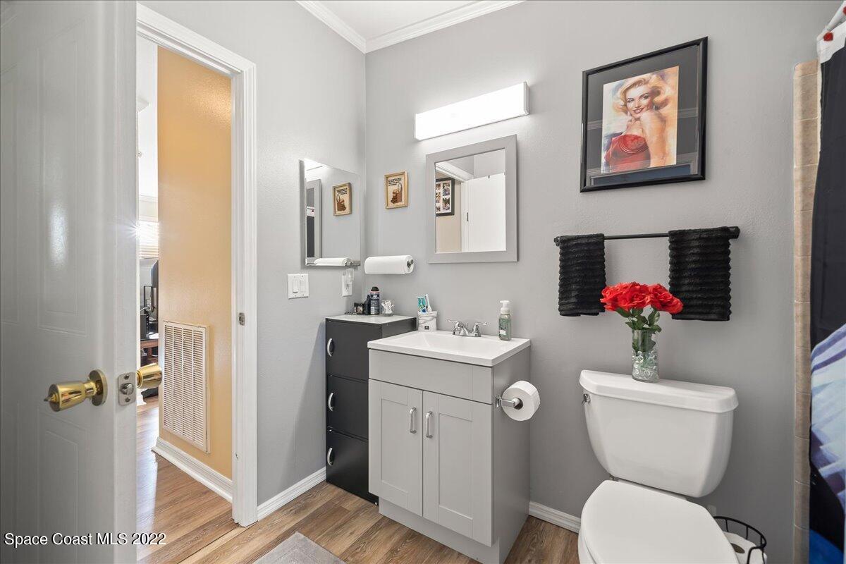 1017 Barefoot Circle Sebastian, FL 32976 - Photo 26 of 33 a bathroom with a toilet sink and mirror
