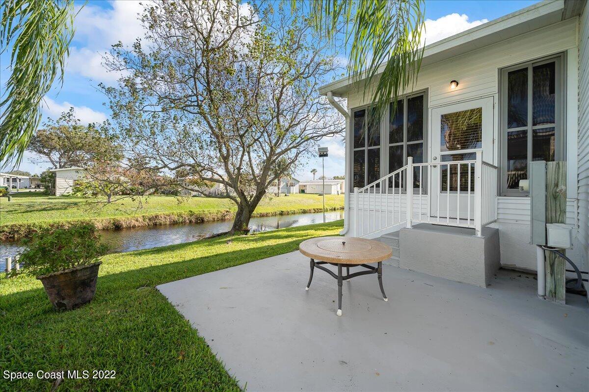 1017 Barefoot Circle Sebastian, FL 32976 - Photo 3 of 33 a white bench sitting in front of a house with a yard