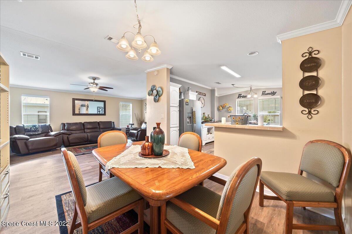 1017 Barefoot Circle Sebastian, FL 32976 - Photo 10 of 33 a view of a dining room with furniture and chandelier