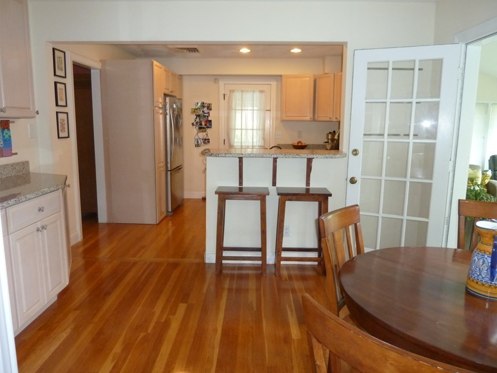 18 Glendale Road Marblehead, MA 01945 - Photo 11 of 29 a dining room with stainless steel appliances wooden floor and a view of kitchen