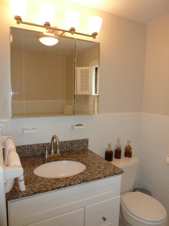 18 Glendale Road Marblehead, MA 01945 - Photo 18 of 29 a bathroom with a granite countertop sink and a mirror
