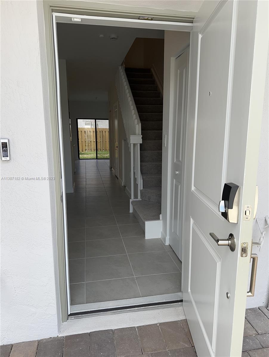 Miami-Dade County Homestead, FL 33032 - Photo 3 of 30 a view of a hallway with wooden floor and staircase
