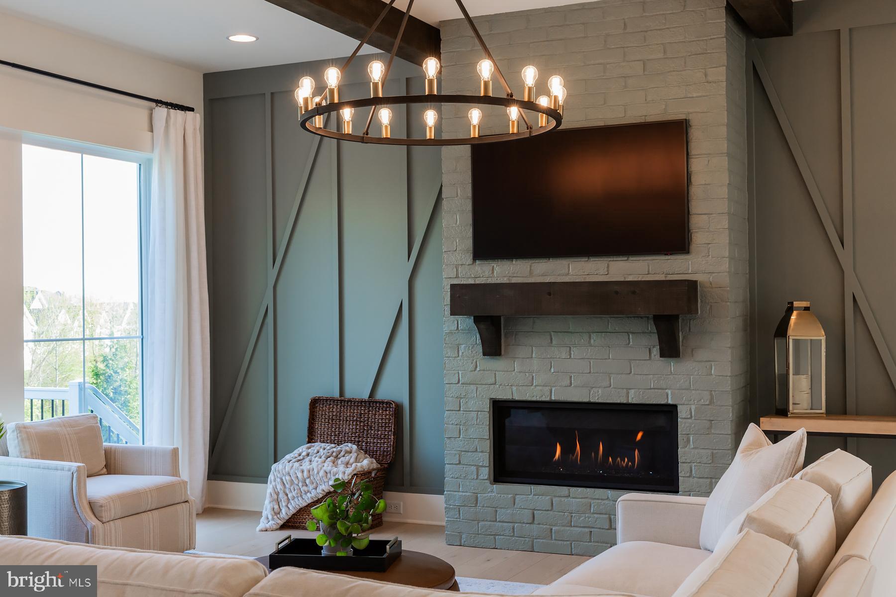 1016 Valley Crossing Drive Lititz, PA 17543 - Photo 19 of 85 a living room with furniture a fireplace and a flat screen tv