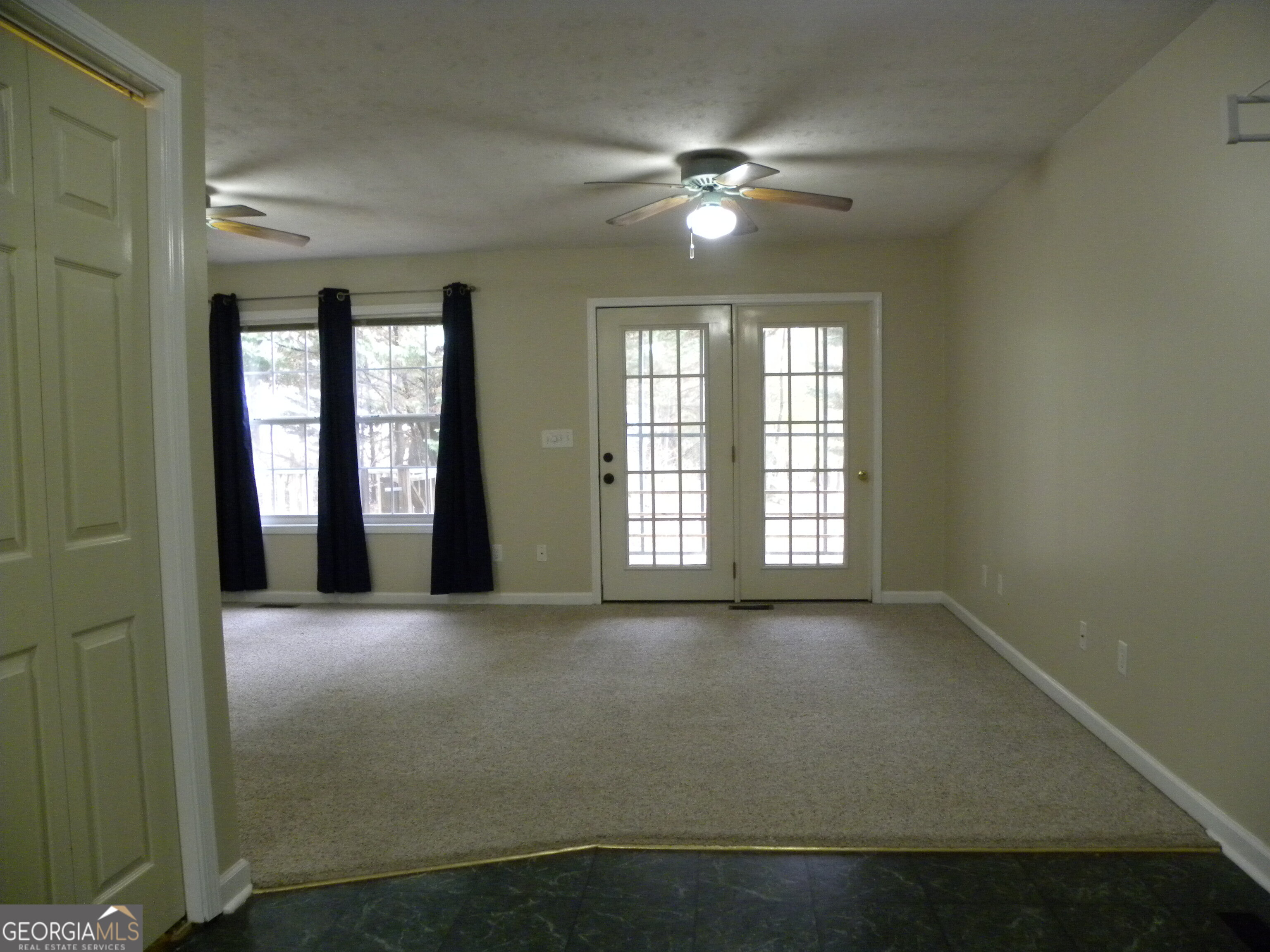101 And 103 Joy Lane, Unit DUPLEX Hartwell, GA 30643 - Photo 12 of 24 an empty room with chandelier fan and windows